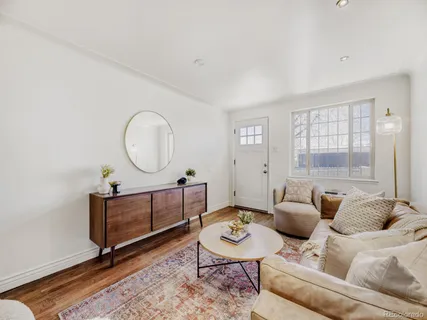 a living room with furniture a window and a table