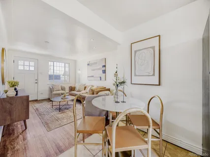 a view of a dining room with furniture and chandelier