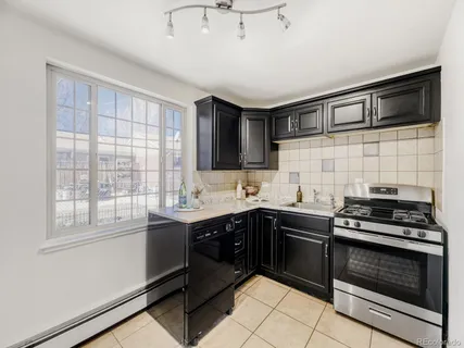 a kitchen with stainless steel appliances a stove sink and cabinets