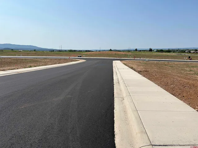 a view of swimming pool with lake view and mountain in the back
