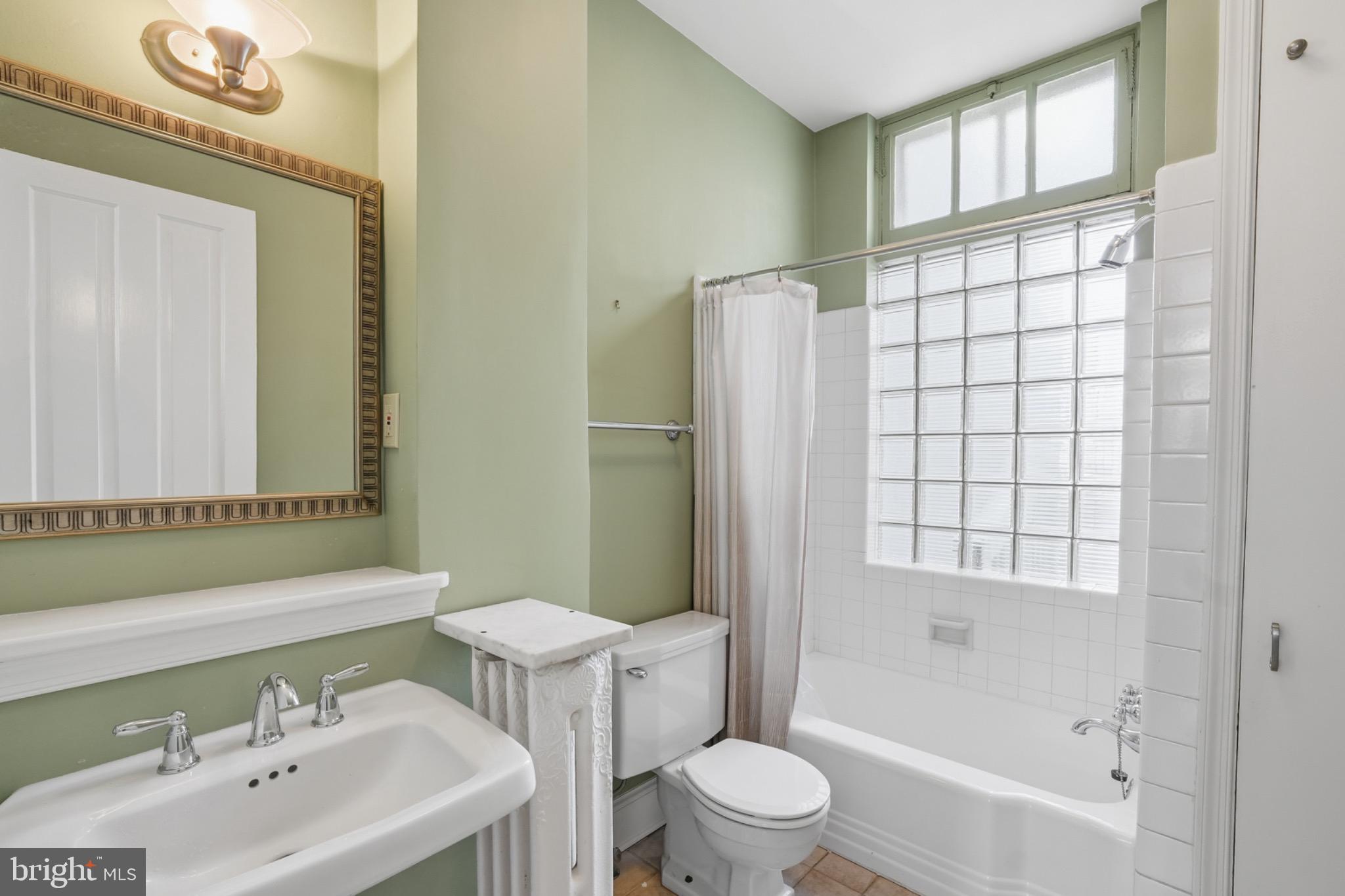 1635 35th Street Northwest Washington, DC 20007 - Photo 13 of 27 a bathroom with a sink toilet and shower