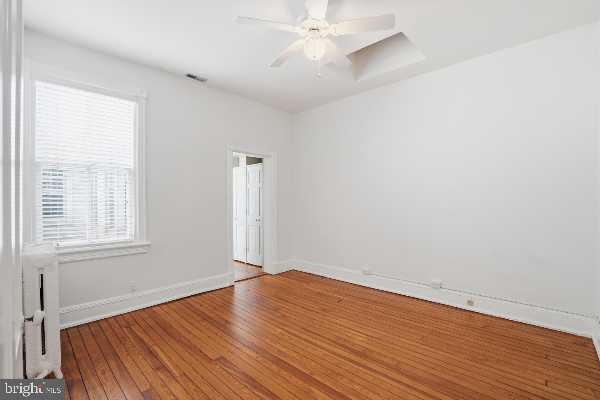 1635 35th Street Northwest Washington, DC 20007 - Photo 14 of 27 wooden floor in an empty room with a window