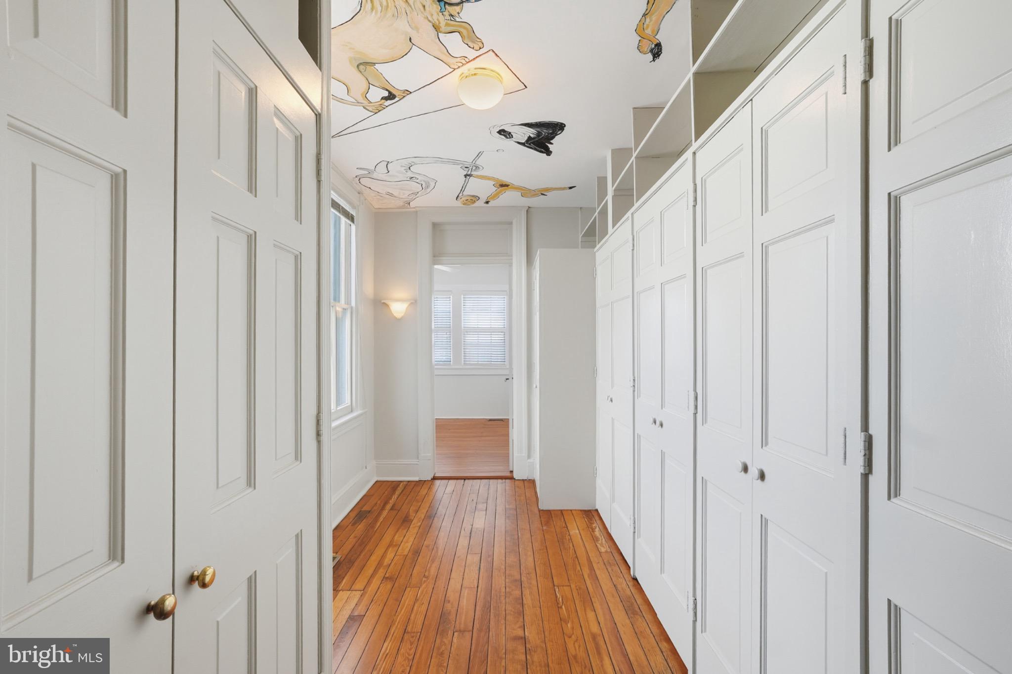 1635 35th Street Northwest Washington, DC 20007 - Photo 16 of 27 a view of a hallway with wooden floor and staircase