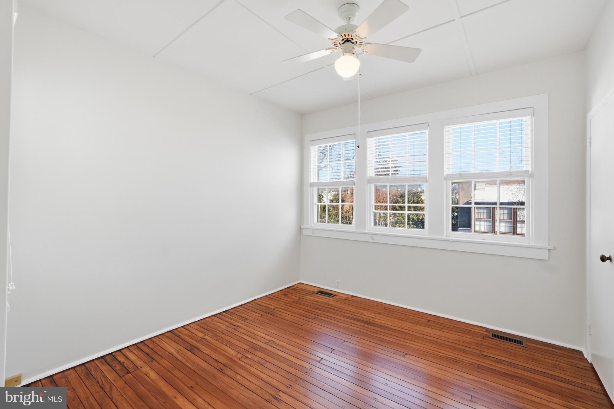 1635 35th Street Northwest Washington, DC 20007 - Photo 18 of 27 wooden floor in an empty room with a window