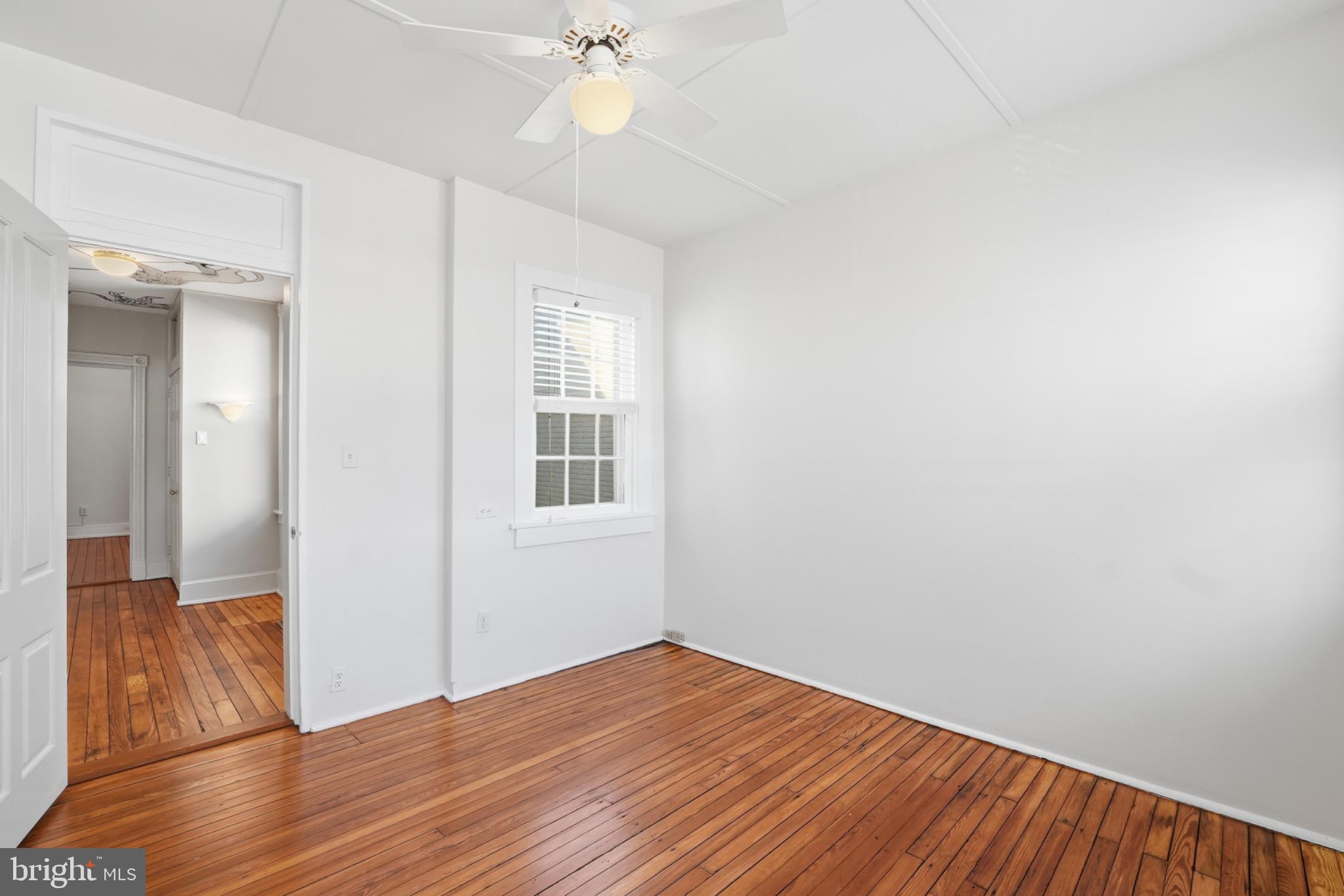 1635 35th Street Northwest Washington, DC 20007 - Photo 19 of 27 a view of empty room with wooden floor and fan