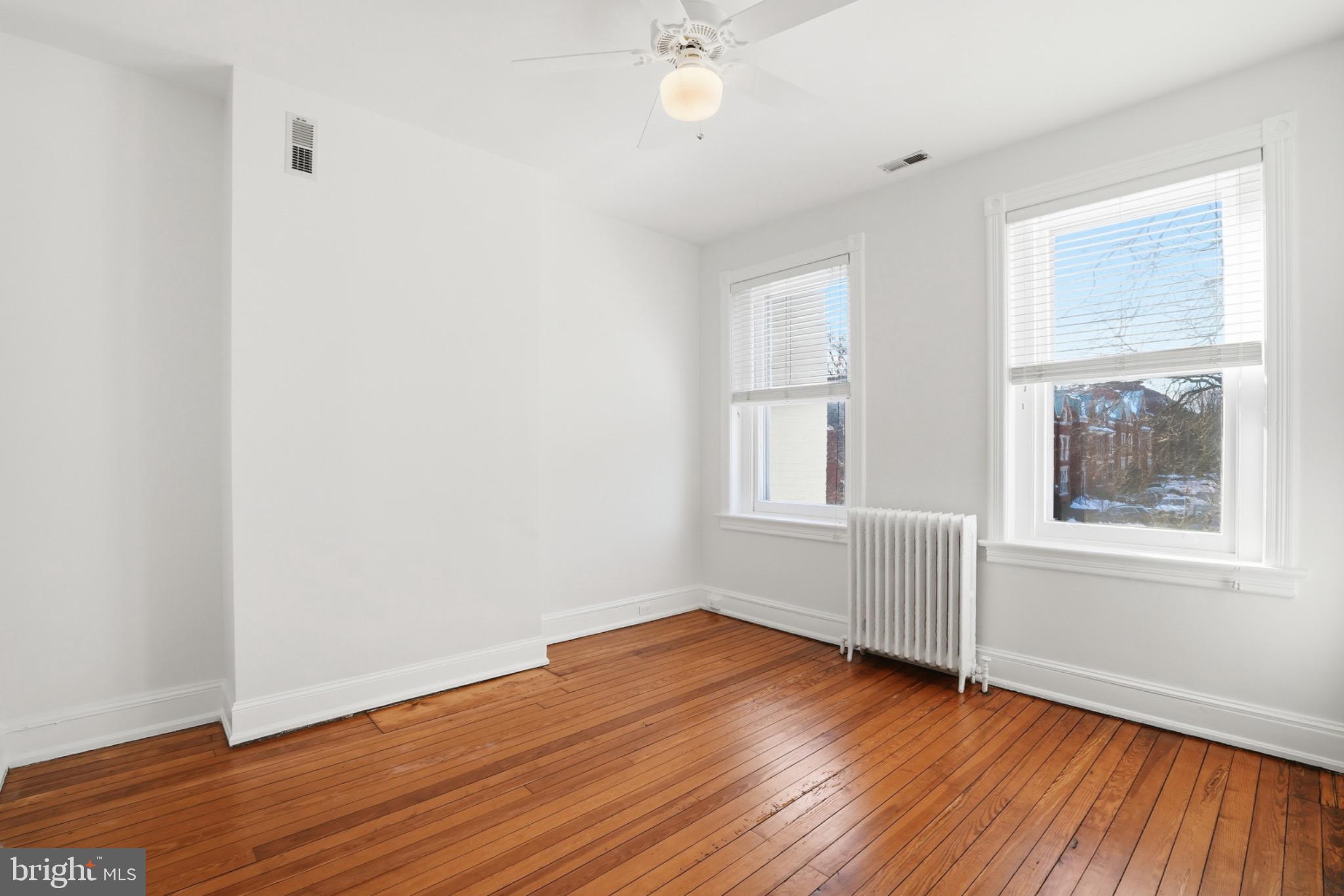 1635 35th Street Northwest Washington, DC 20007 - Photo 20 of 27 an empty room with wooden floor and windows