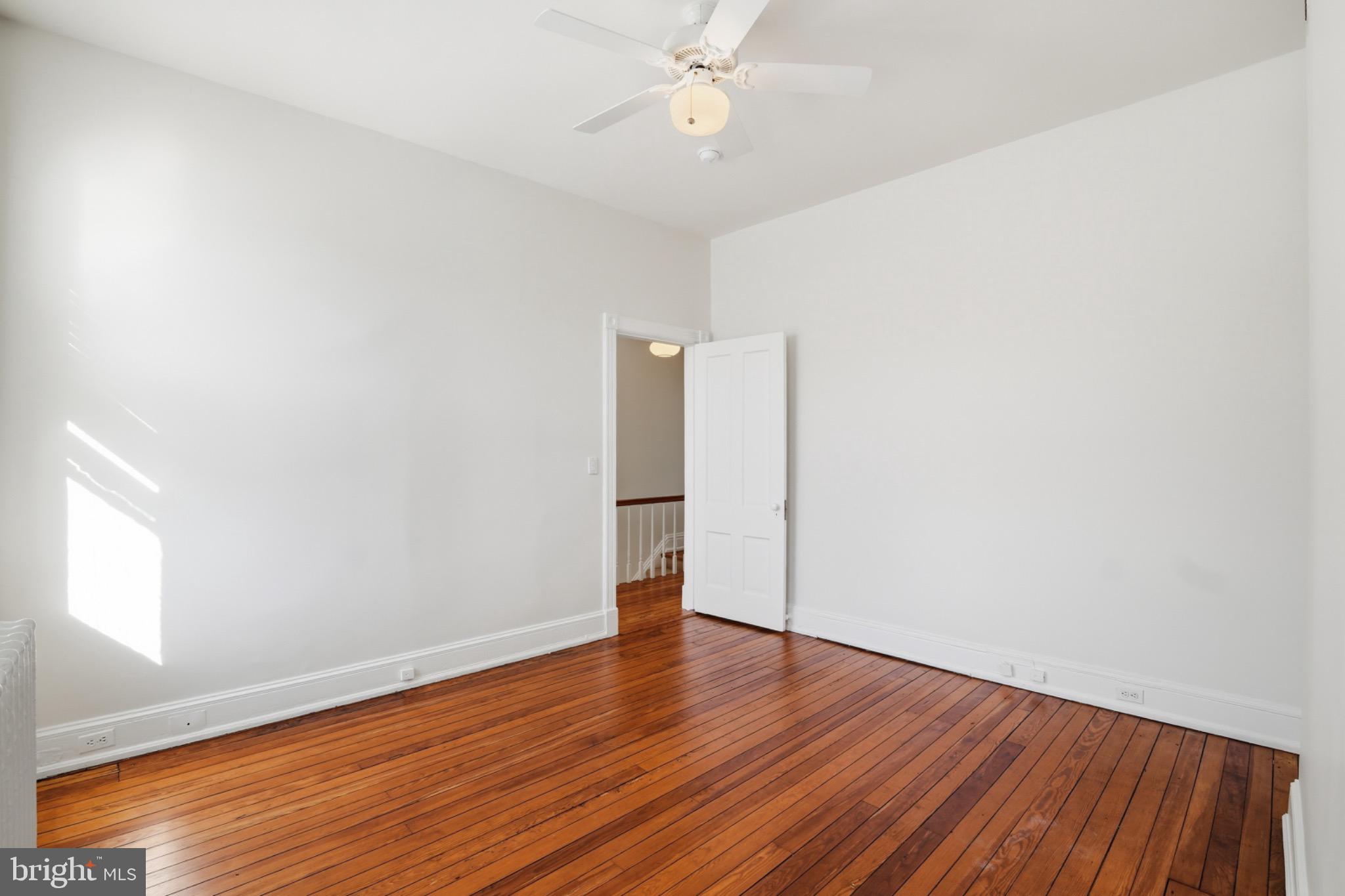 1635 35th Street Northwest Washington, DC 20007 - Photo 21 of 27 an empty room with wooden floor and door