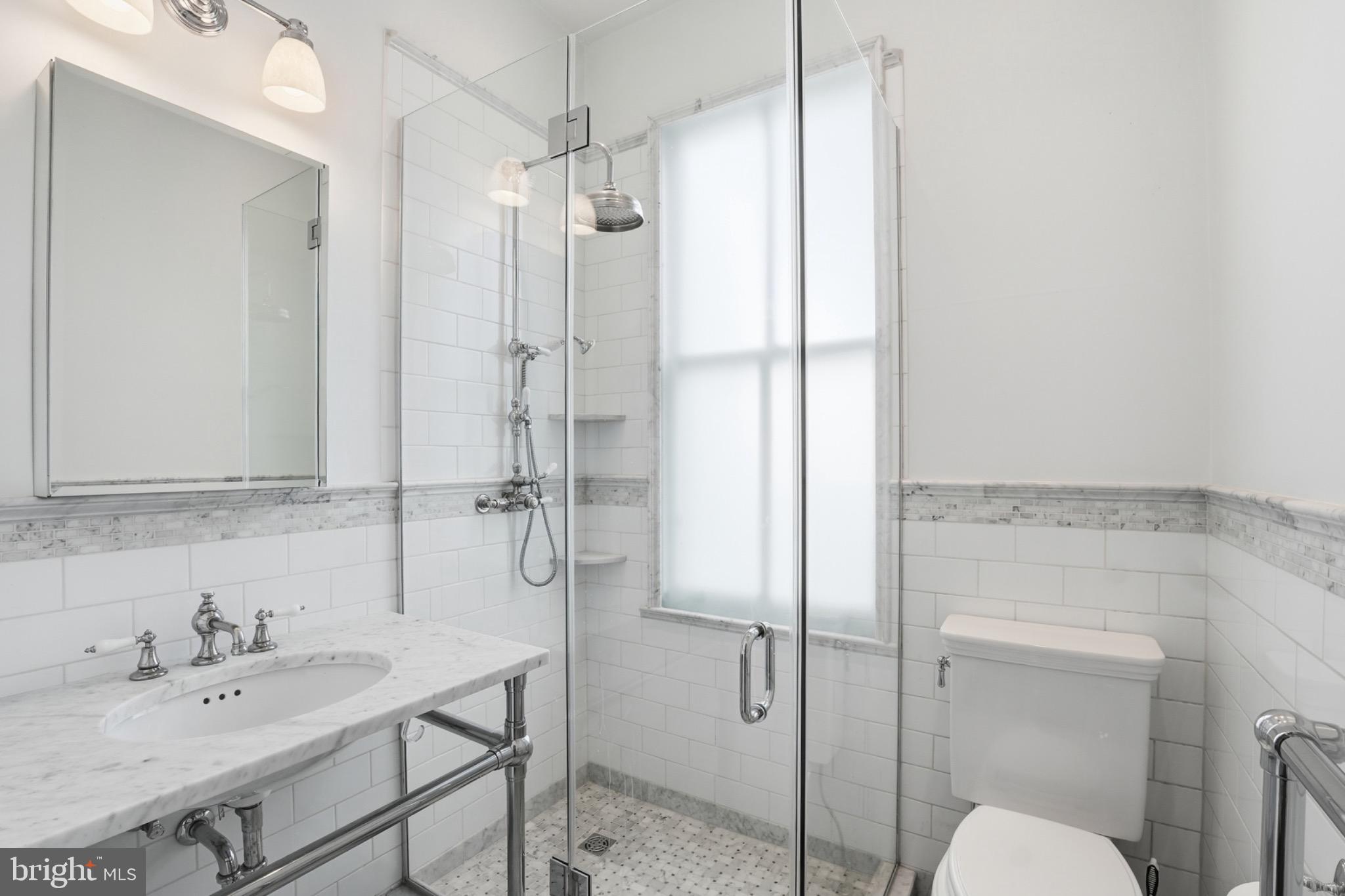 1635 35th Street Northwest Washington, DC 20007 - Photo 23 of 27 a bathroom with a granite countertop sink shower and a mirror