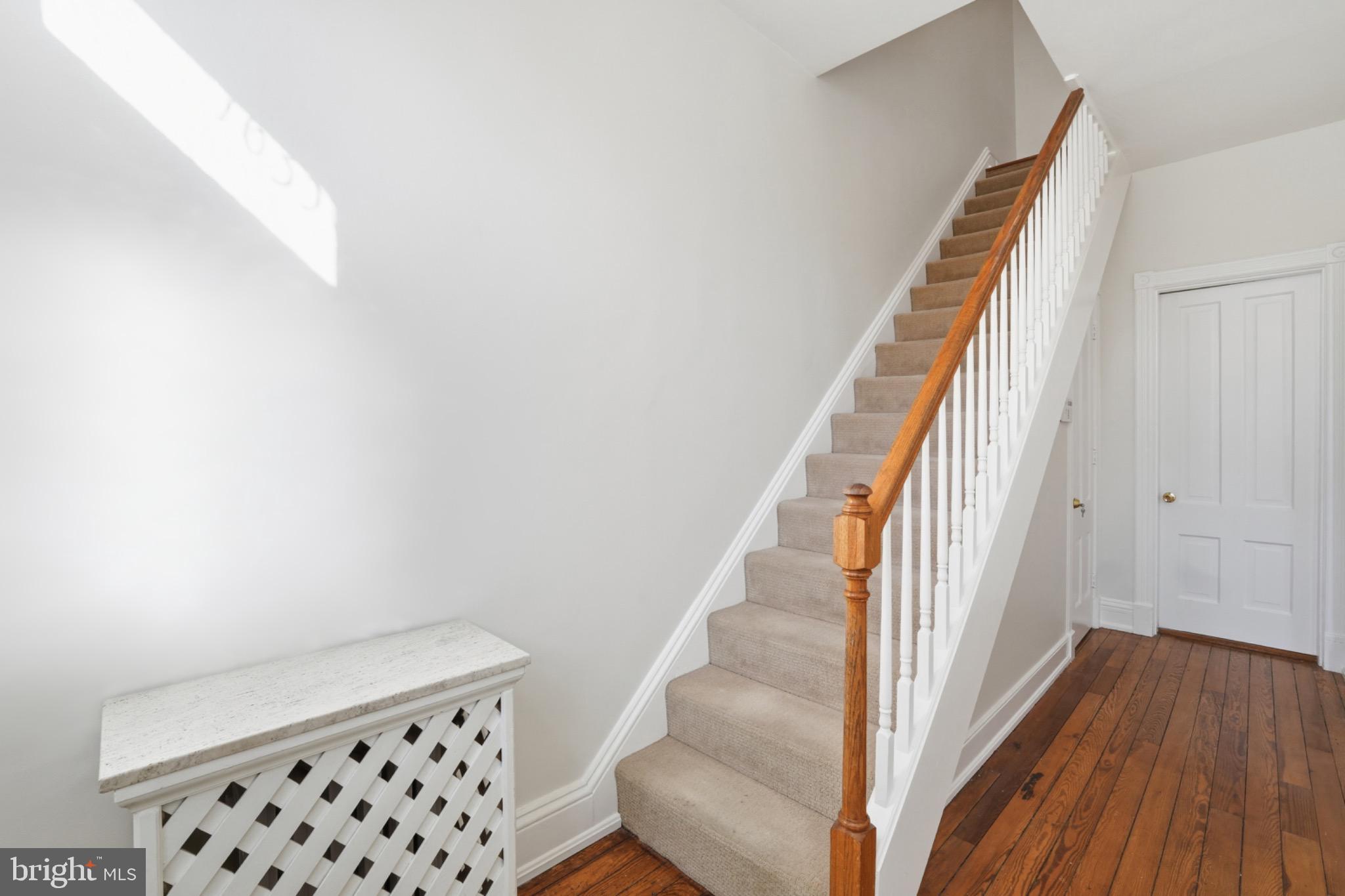 1635 35th Street Northwest Washington, DC 20007 - Photo 4 of 27 a view of staircase with wooden floor and white walls