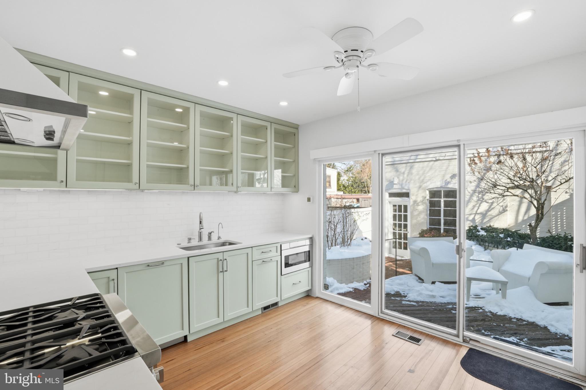 1635 35th Street Northwest Washington, DC 20007 - Photo 10 of 27 a kitchen with a sink and wooden cabinets