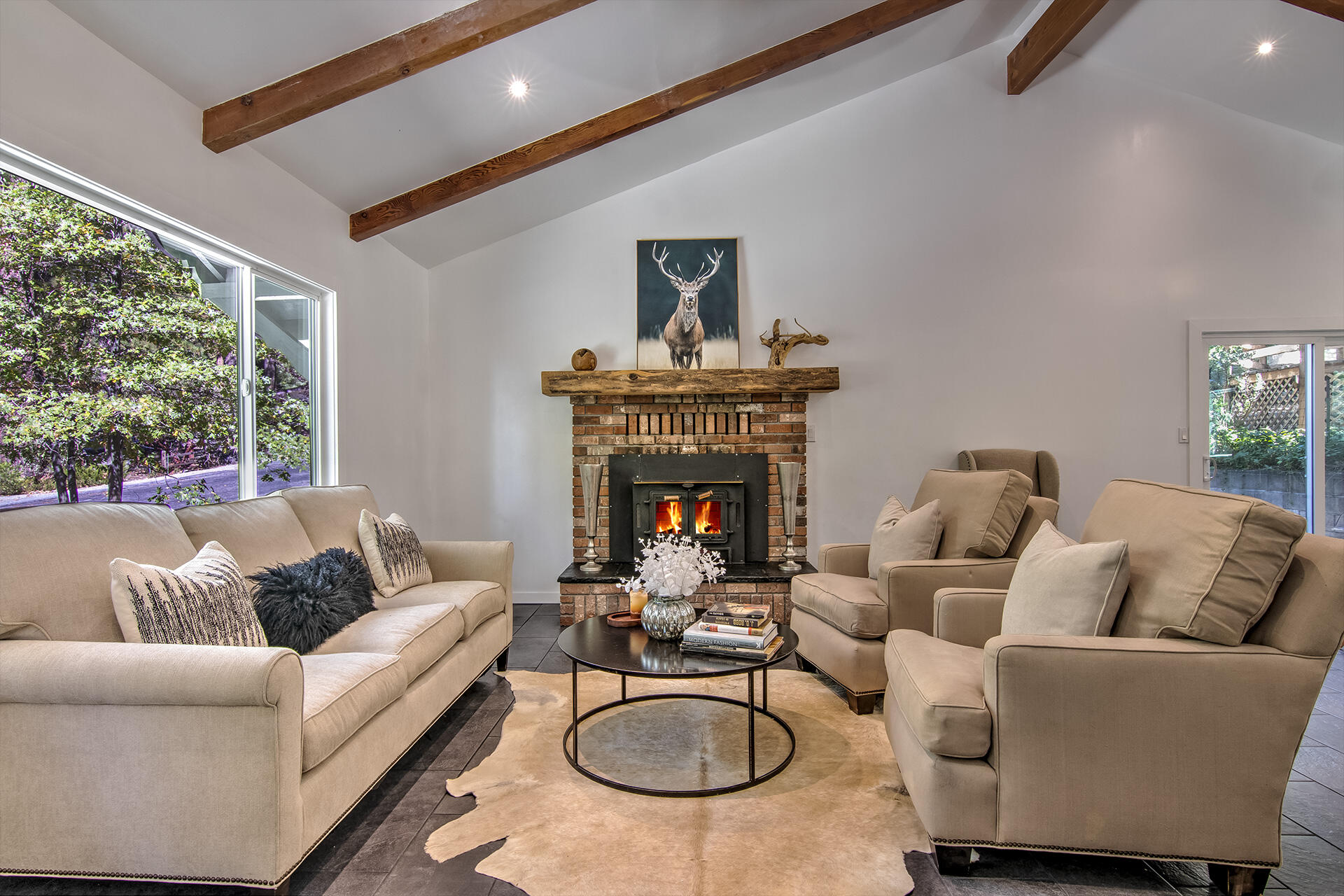 25106 Rim Rock Road Idyllwild, CA 92549 - Photo 11 of 90 a living room with furniture a fireplace and a large window