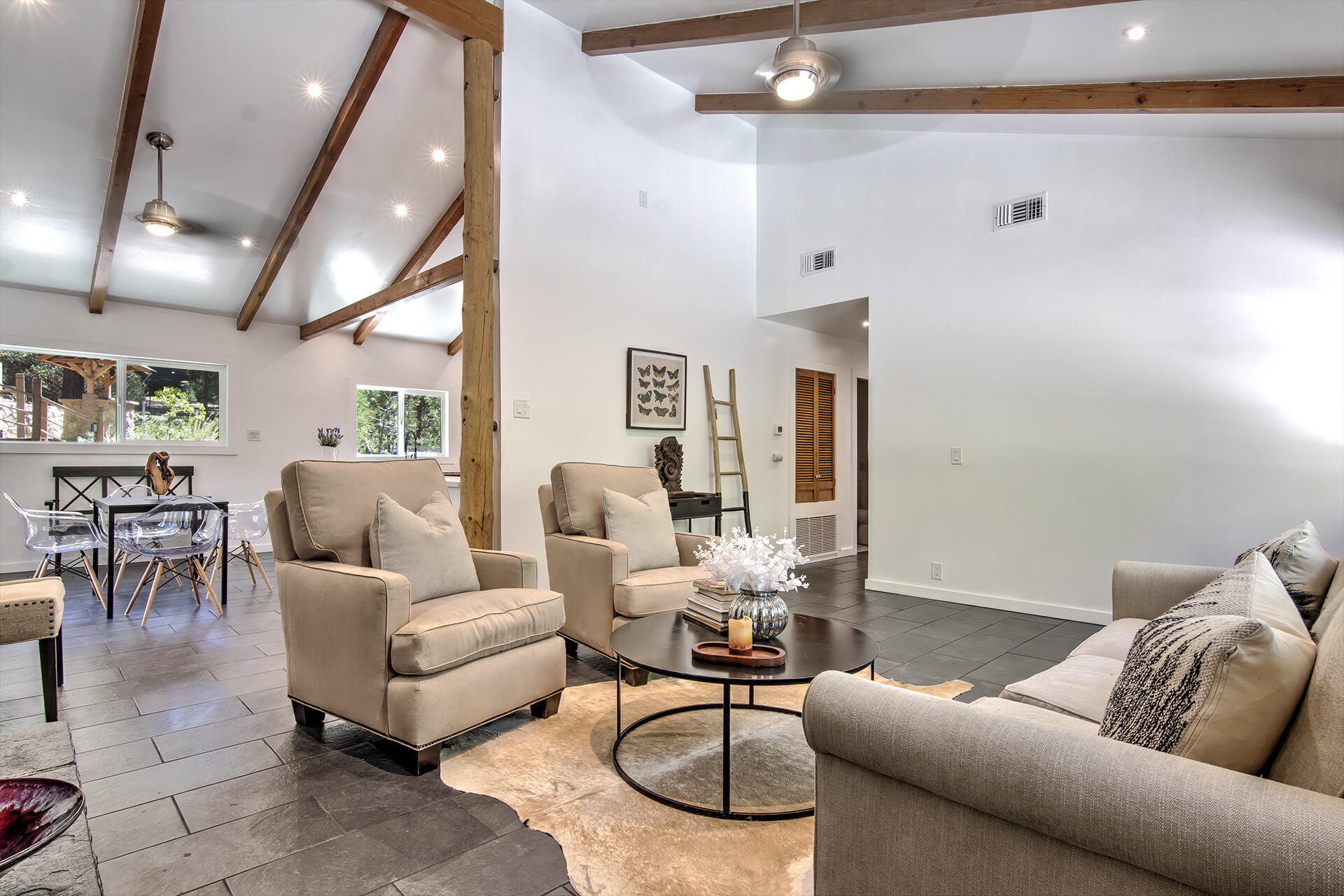25106 Rim Rock Road Idyllwild, CA 92549 - Photo 14 of 90 a living room with furniture a rug and a chandelier