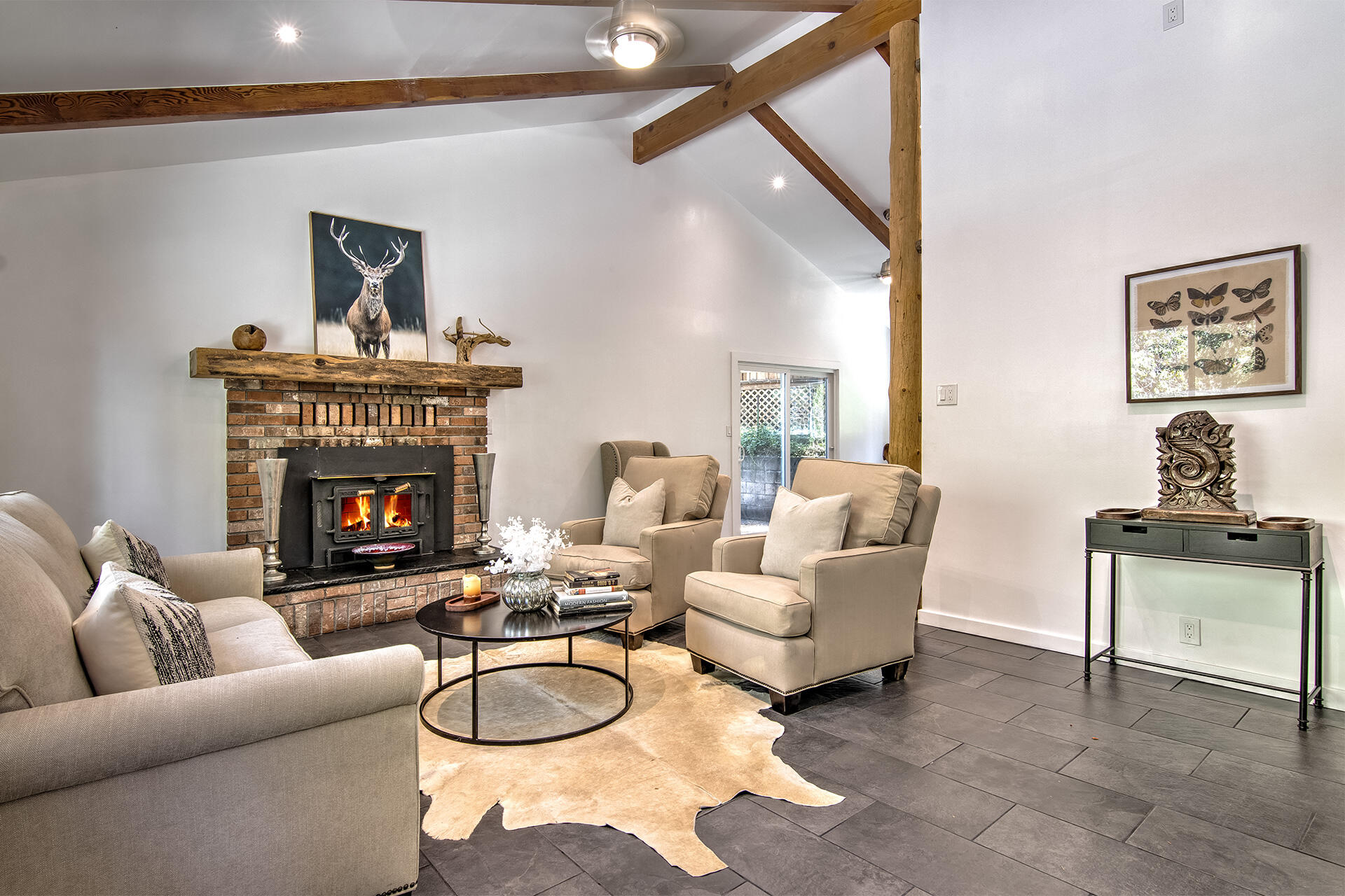 25106 Rim Rock Road Idyllwild, CA 92549 - Photo 2 of 90 a living room with furniture a window and a fireplace