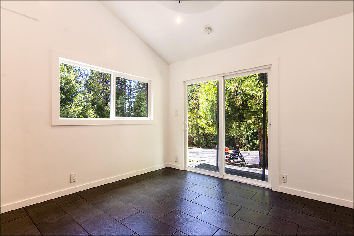 25106 Rim Rock Road Idyllwild, CA 92549 - Photo 34 of 90 a view of an empty room with wooden floor and a window