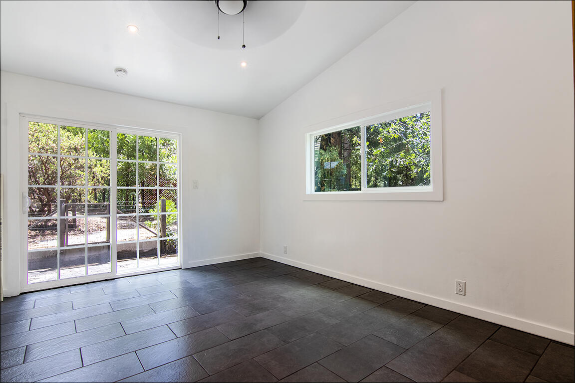25106 Rim Rock Road Idyllwild, CA 92549 - Photo 35 of 90 a view of an empty room with wooden floor and a window