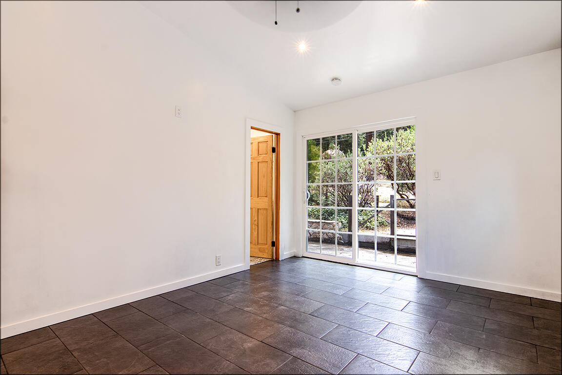25106 Rim Rock Road Idyllwild, CA 92549 - Photo 36 of 90 a view of an empty room with wooden floor and a window