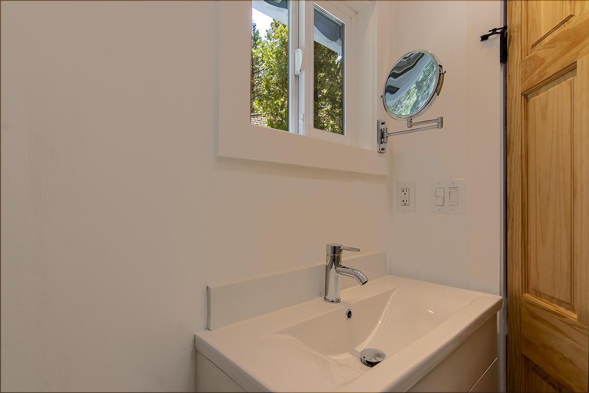 25106 Rim Rock Road Idyllwild, CA 92549 - Photo 38 of 90 a bathroom with a sink and a window