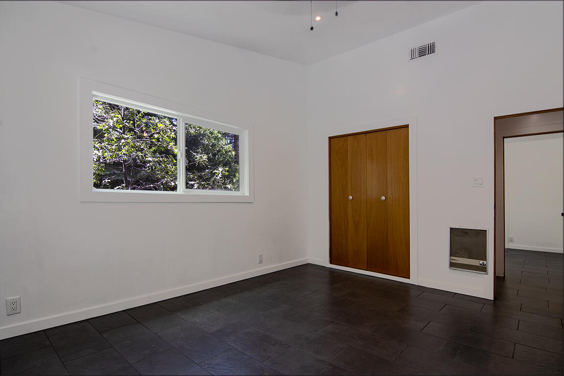 25106 Rim Rock Road Idyllwild, CA 92549 - Photo 39 of 90 a view of an empty room with wooden floor and a window