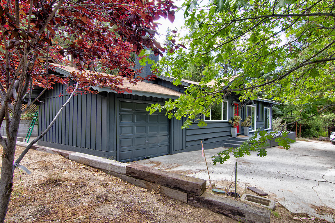 25106 Rim Rock Road Idyllwild, CA 92549 - Photo 5 of 90 a view of a house with a small yard plants and large tree