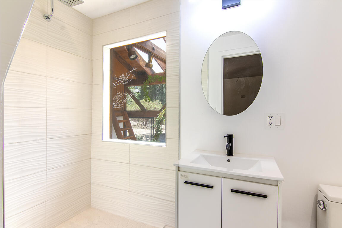 25106 Rim Rock Road Idyllwild, CA 92549 - Photo 59 of 90 a bathroom with a sink and a mirror