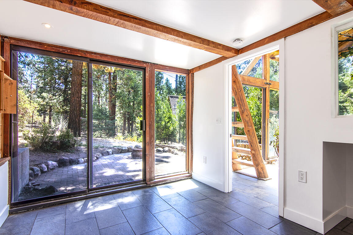 25106 Rim Rock Road Idyllwild, CA 92549 - Photo 73 of 90 a view of a room with wooden floor and door
