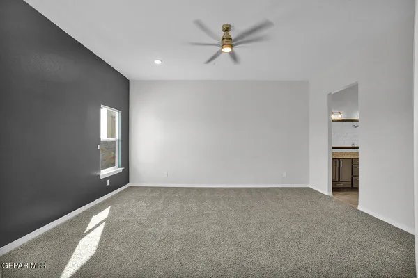 a view of an empty room with windows and closet