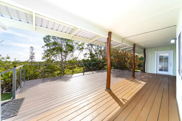a large kitchen with stainless steel appliances wooden floors and wooden cabinets
