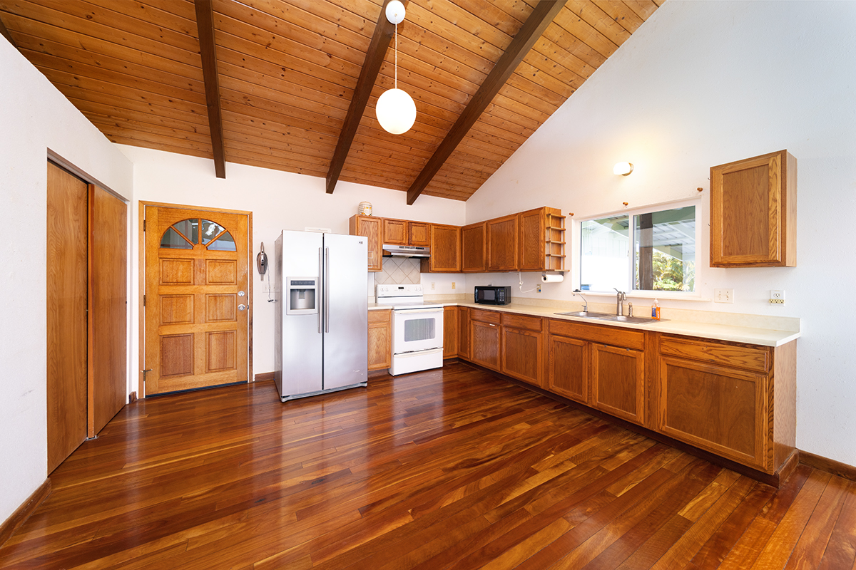 25-3301 Pakelekia Street Hilo, HI 96720 - Photo 16 of 30 a large kitchen with stainless steel appliances wooden floors and wooden cabinets