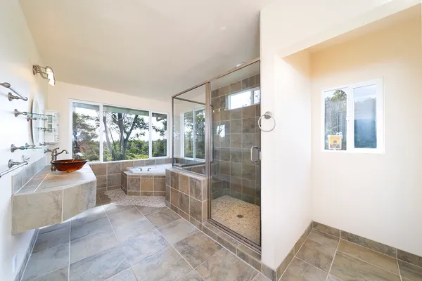 a bathroom with a tub sink and shower