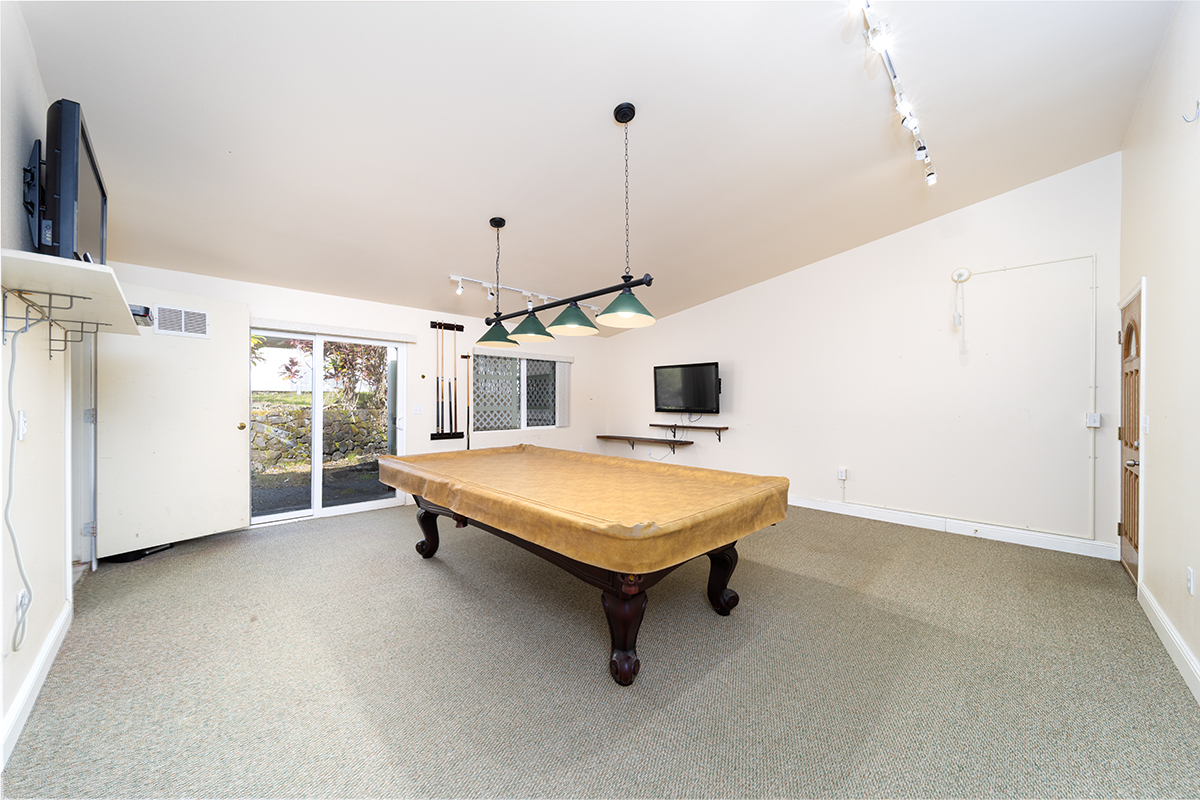 25-3301 Pakelekia Street Hilo, HI 96720 - Photo 24 of 30 a living room with a table chair and a refrigerator