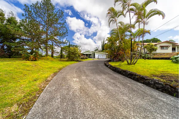 a view of a house with a yard and garage