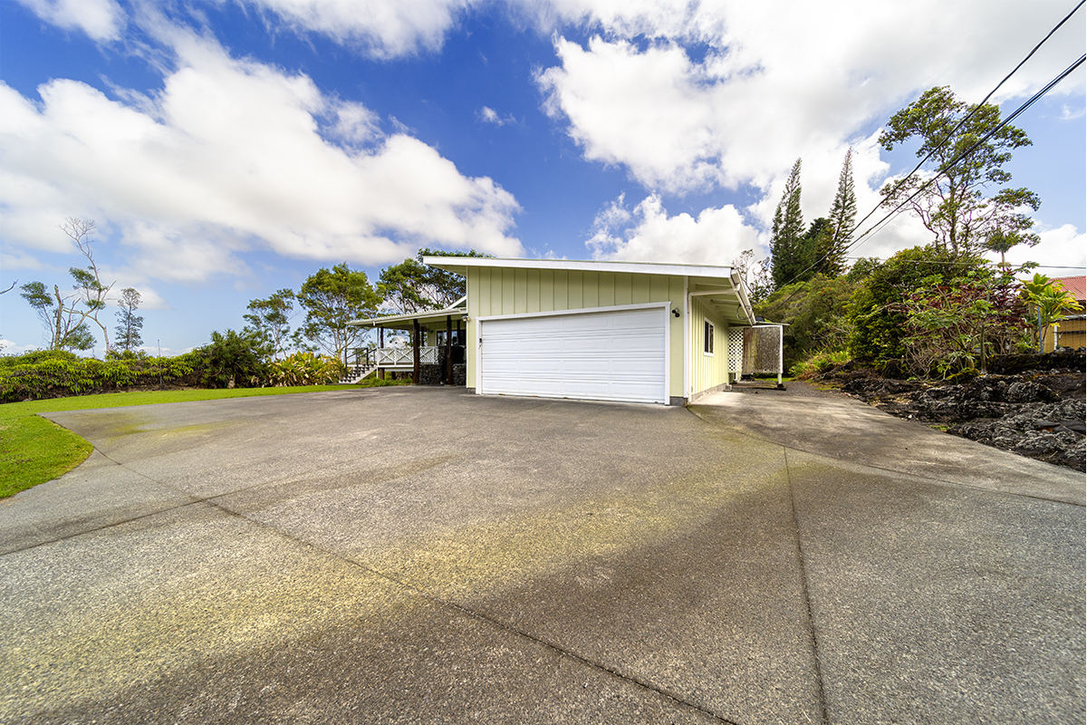 25-3301 Pakelekia Street Hilo, HI 96720 - Photo 5 of 30 a view of a house with a yard and garage