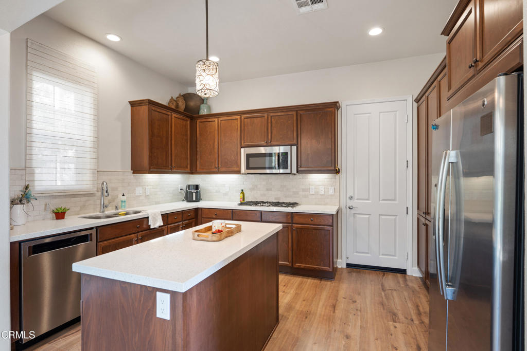 1655 Range Road Oxnard, CA 93036 - Photo 13 of 33 a kitchen with stainless steel appliances granite countertop a sink stove and refrigerator
