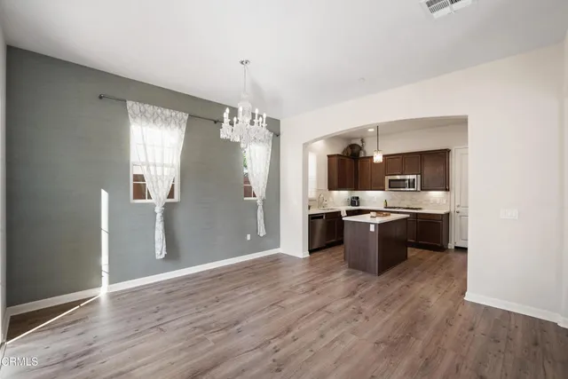 a large kitchen with a wooden floor and a view of kitchen