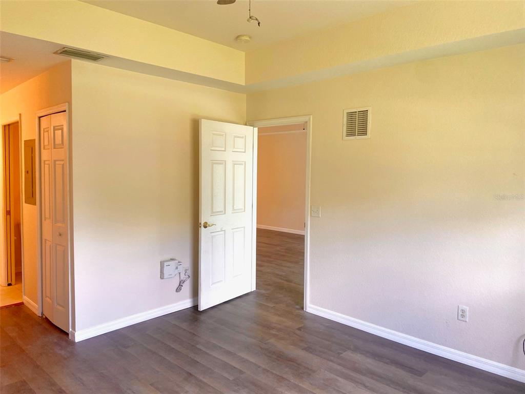 5771 Sabal Trace Drive, Unit 102 B5771 North Port, FL 34287 - Photo 16 of 37 a view of an empty room with wooden floor and a window