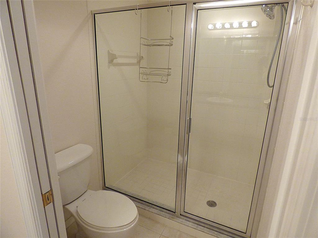 5771 Sabal Trace Drive, Unit 102 B5771 North Port, FL 34287 - Photo 21 of 37 a white toilet sitting next to a shower