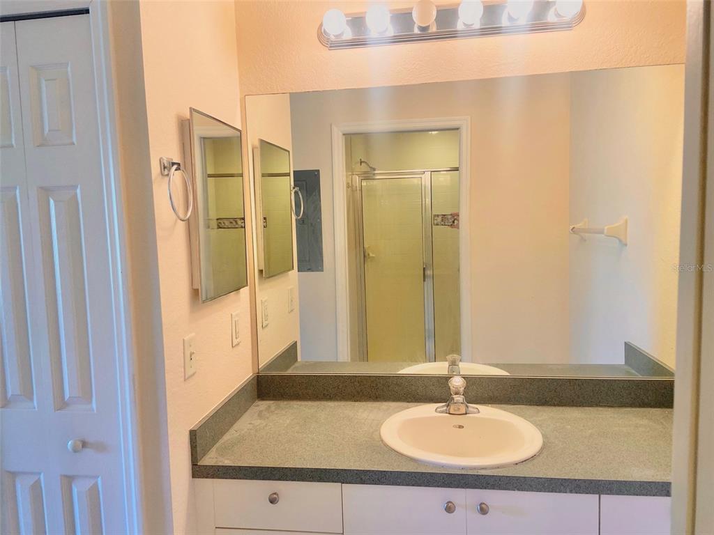 5771 Sabal Trace Drive, Unit 102 B5771 North Port, FL 34287 - Photo 22 of 37 a bathroom with a sink and a mirror
