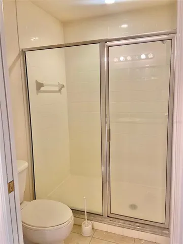 a bathroom with a glass shower door
