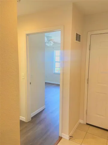 a view of a hallway with wooden floor