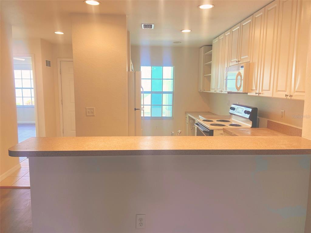5771 Sabal Trace Drive, Unit 102 B5771 North Port, FL 34287 - Photo 3 of 37 a view of a kitchen with a sink and a window