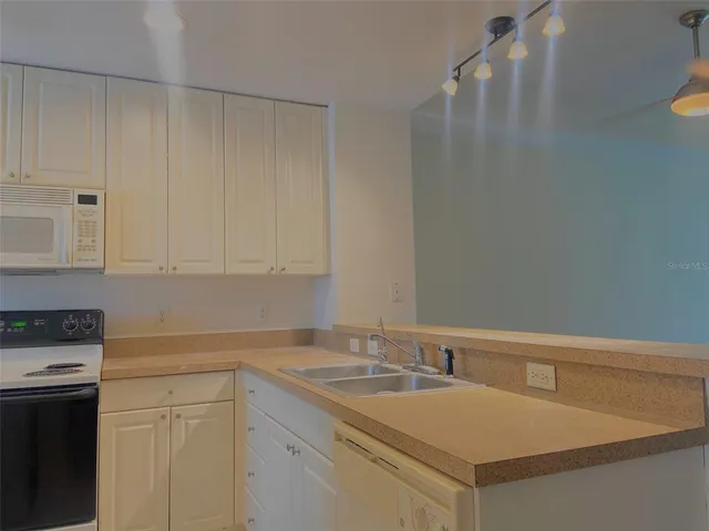 a kitchen with a sink and cabinets