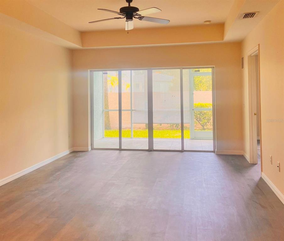 5771 Sabal Trace Drive, Unit 102 B5771 North Port, FL 34287 - Photo 8 of 37 a view of an empty room with a ceiling fan