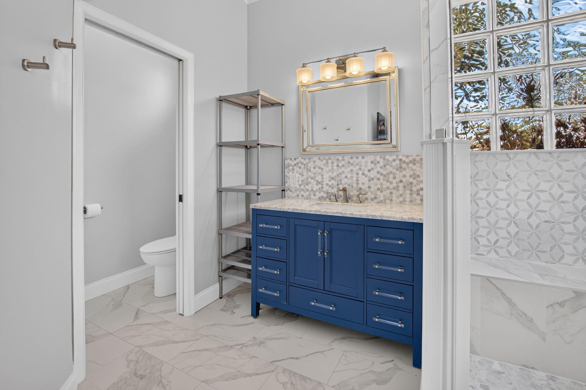 1365 East Barwick Ranch Circle Delray Beach, FL 33445 - Photo 25 of 77 a bathroom with a granite countertop sink a toilet and a mirror