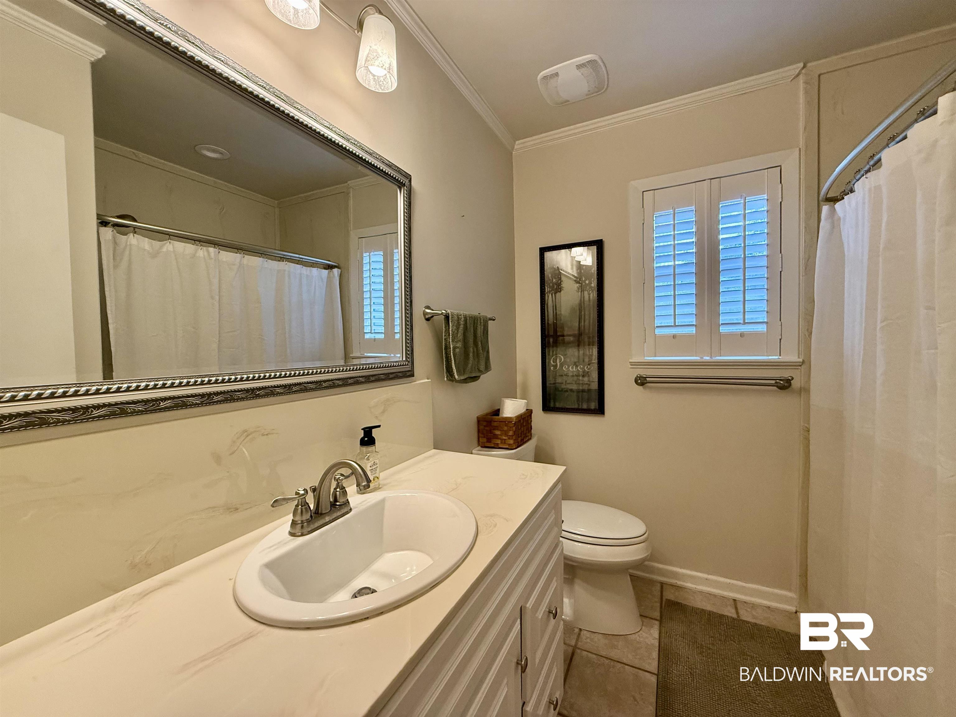 5971 Appleton Road Brewton, AL 36426 - Photo 16 of 23 Full bathroom with vanity, ornamental molding, and tile patterned flooring