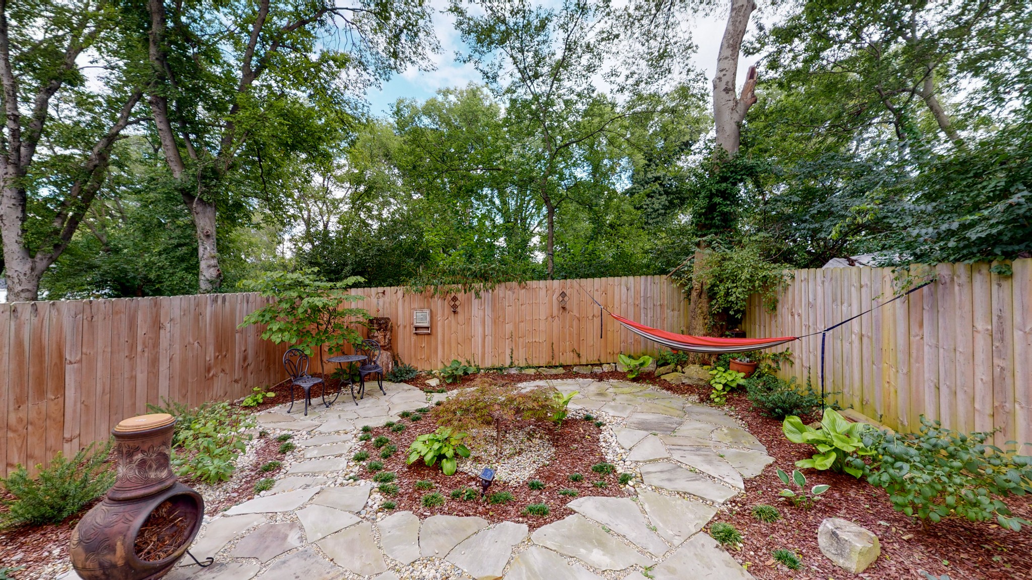 2007 Overby Road, Unit A Nashville, TN 37207 - Photo 14 of 29 a backyard with potted plants and a wooden fence