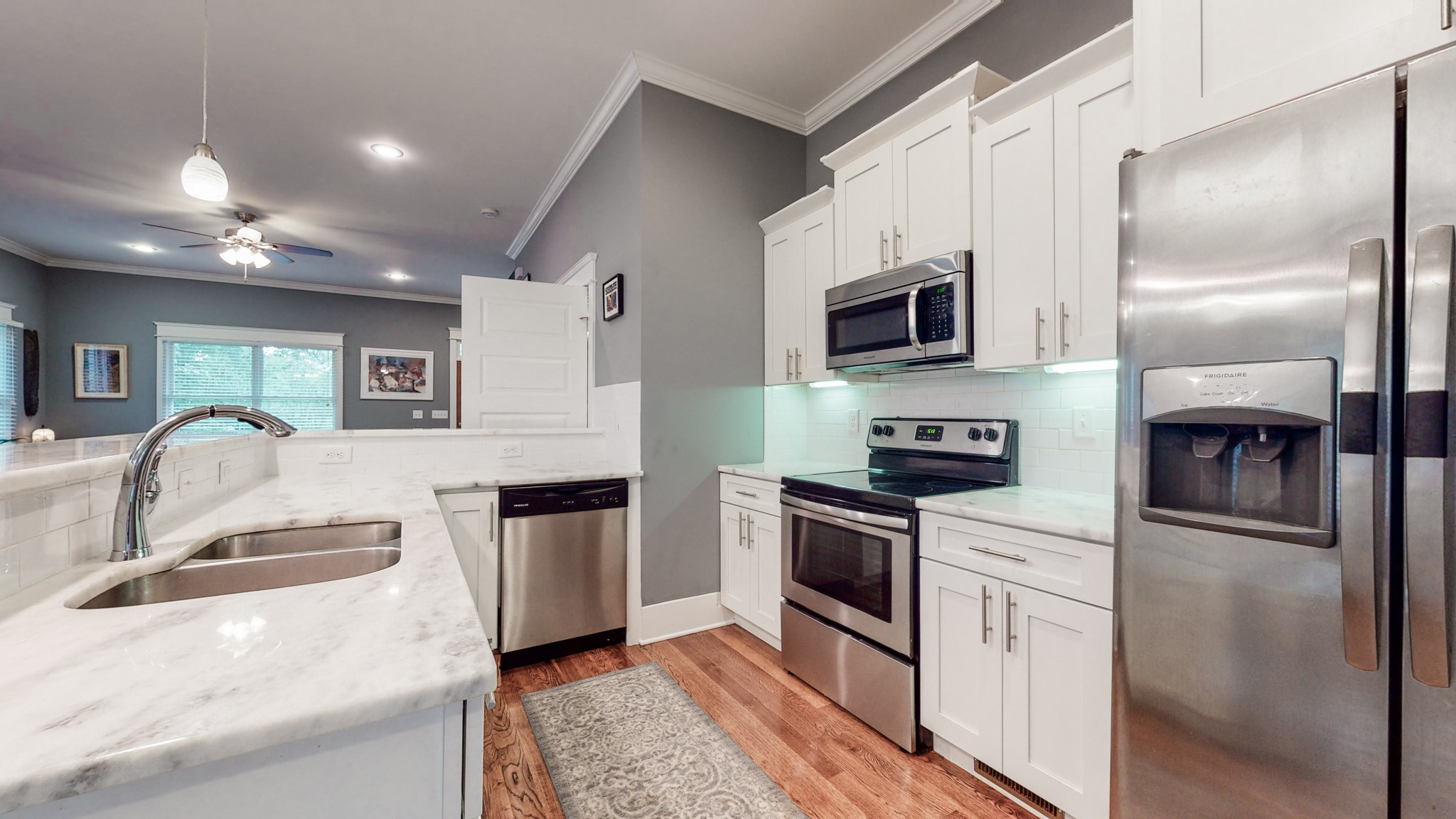 2007 Overby Road, Unit A Nashville, TN 37207 - Photo 7 of 29 a kitchen with stainless steel appliances granite countertop a refrigerator a stove top oven a sink and dishwasher