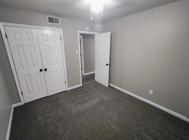 an empty room with closet area