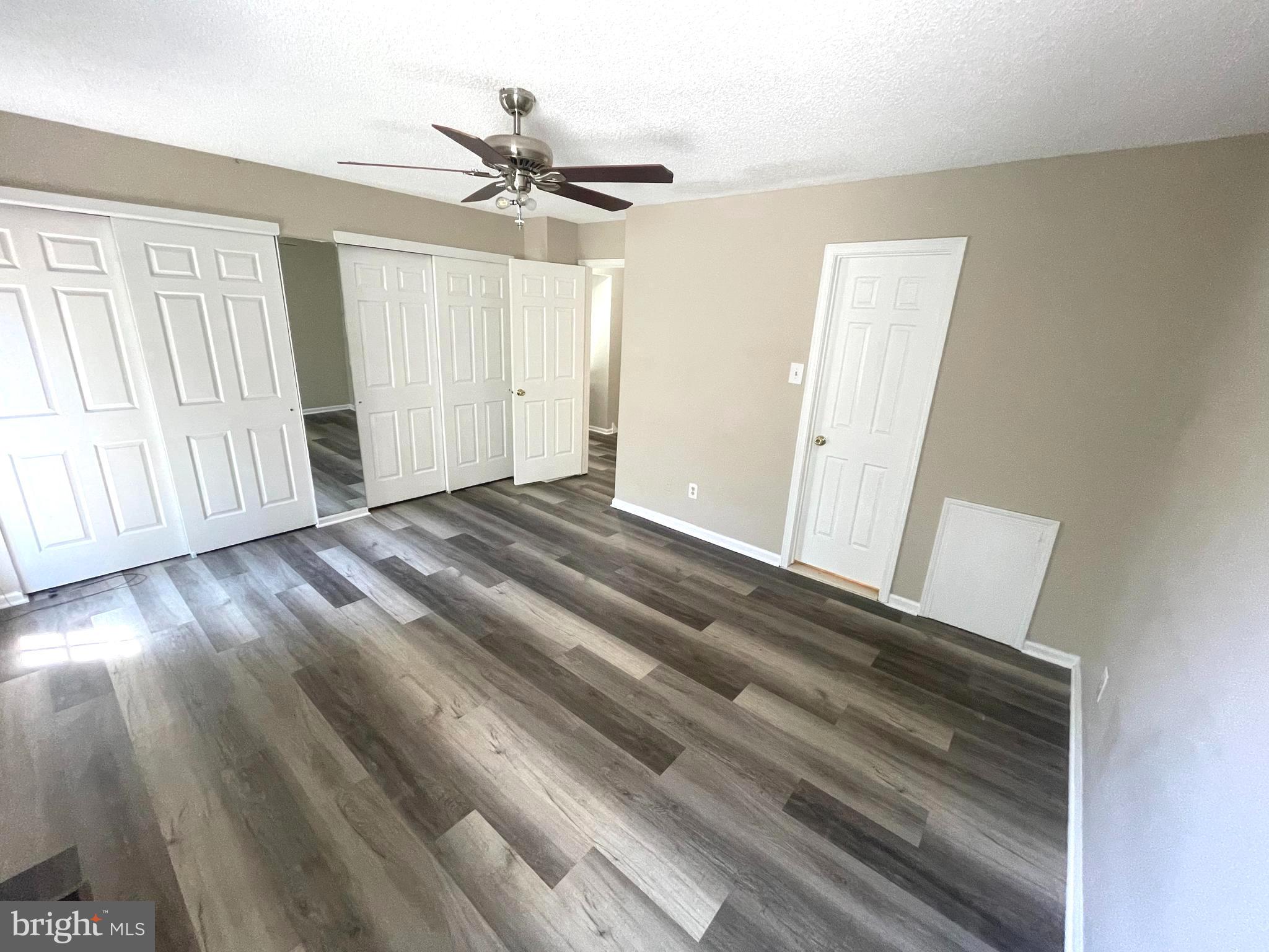 214 Carriage Court, Unit 214 Chesterbrook, PA 19087 - Photo 14 of 41 a view of a livingroom with wooden floor and a ceiling fan
