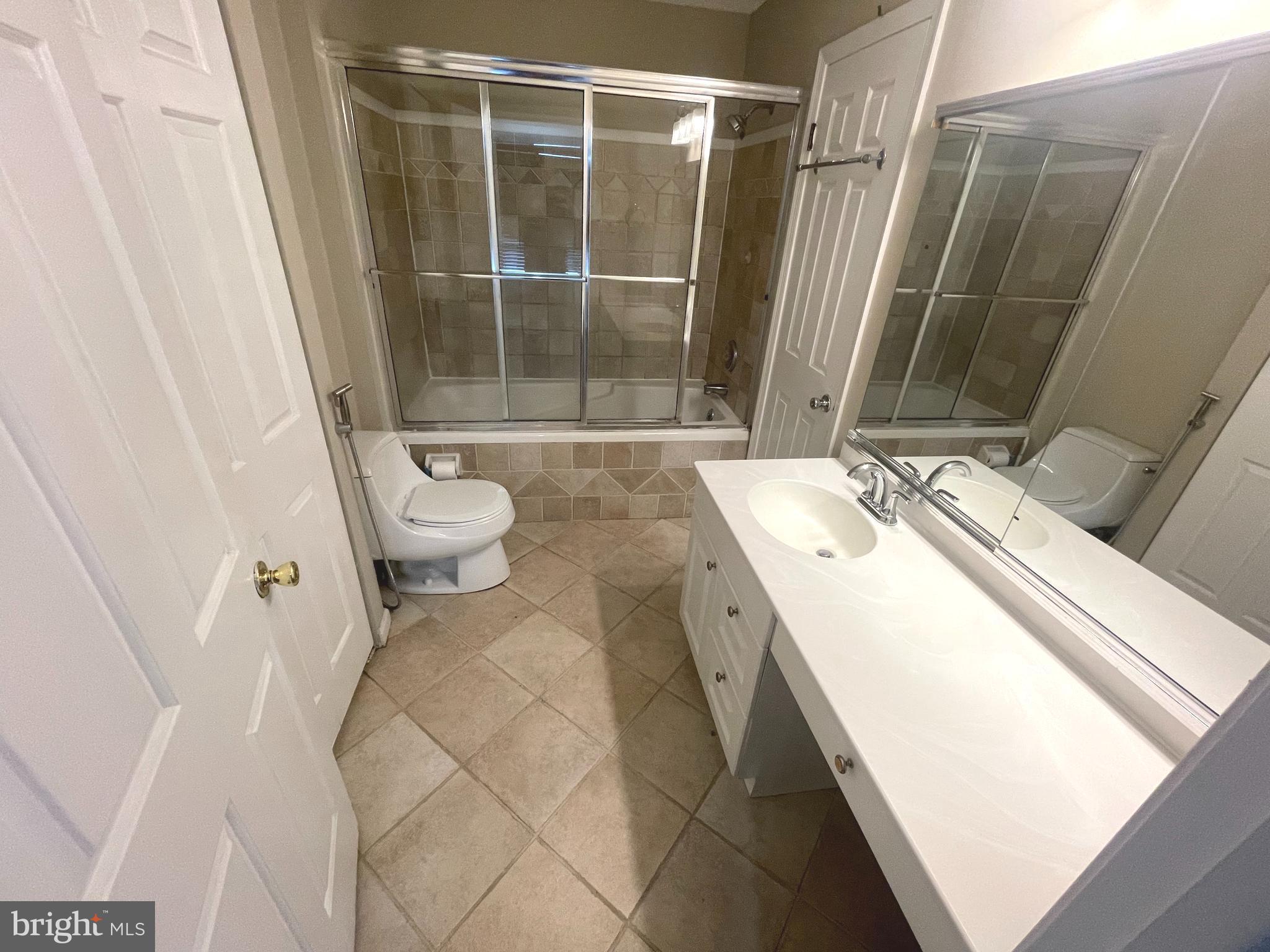 214 Carriage Court, Unit 214 Chesterbrook, PA 19087 - Photo 16 of 41 a bathroom with a granite countertop sink toilet and shower