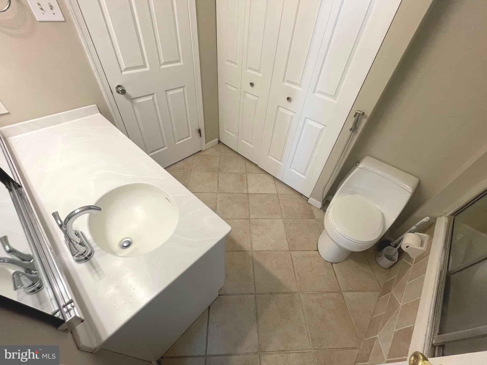 214 Carriage Court, Unit 214 Chesterbrook, PA 19087 - Photo 21 of 41 a bathroom with a toilet a sink and mirror